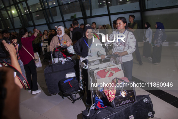 Indonesian citizens (WNI) walk out of the arrivals terminal shortly after arriving from Syria at Soekarno-Hatta Airport in Tangerang, Banten...