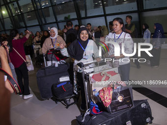 Indonesian citizens (WNI) walk out of the arrivals terminal shortly after arriving from Syria at Soekarno-Hatta Airport in Tangerang, Banten...