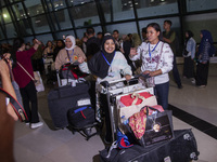 Indonesian citizens (WNI) walk out of the arrivals terminal shortly after arriving from Syria at Soekarno-Hatta Airport in Tangerang, Banten...