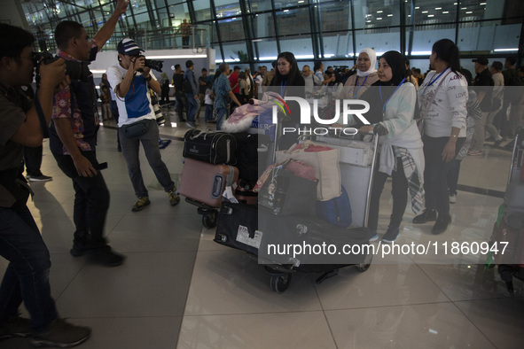 Indonesian citizens (WNI) walk out of the arrivals terminal shortly after arriving from Syria at Soekarno-Hatta Airport in Tangerang, Banten...