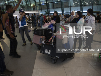 Indonesian citizens (WNI) walk out of the arrivals terminal shortly after arriving from Syria at Soekarno-Hatta Airport in Tangerang, Banten...