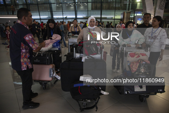 Indonesian citizens (WNI) walk out of the arrivals terminal shortly after arriving from Syria at Soekarno-Hatta Airport in Tangerang, Banten...