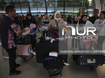 Indonesian citizens (WNI) walk out of the arrivals terminal shortly after arriving from Syria at Soekarno-Hatta Airport in Tangerang, Banten...