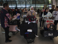 Indonesian citizens (WNI) walk out of the arrivals terminal shortly after arriving from Syria at Soekarno-Hatta Airport in Tangerang, Banten...