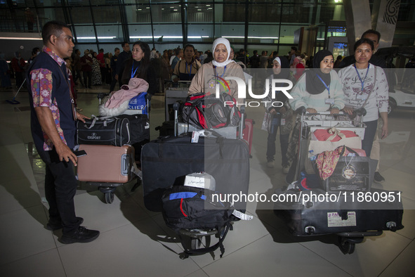 Indonesian citizens (WNI) walk out of the arrivals terminal shortly after arriving from Syria at Soekarno-Hatta Airport in Tangerang, Banten...