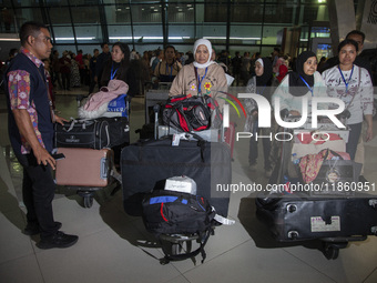 Indonesian citizens (WNI) walk out of the arrivals terminal shortly after arriving from Syria at Soekarno-Hatta Airport in Tangerang, Banten...