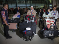 Indonesian citizens (WNI) walk out of the arrivals terminal shortly after arriving from Syria at Soekarno-Hatta Airport in Tangerang, Banten...