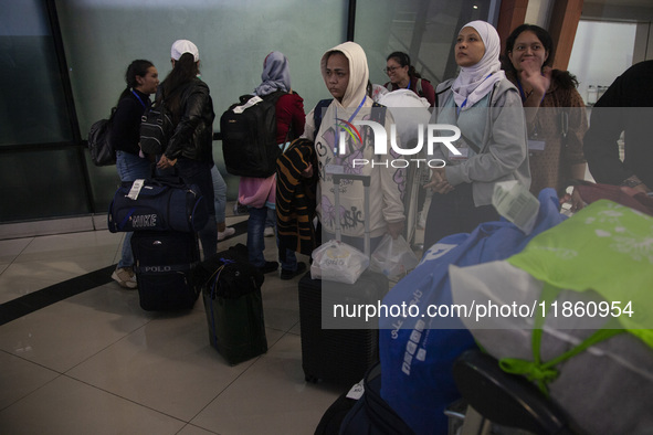 Indonesian citizens (WNI) walk out of the arrivals terminal shortly after arriving from Syria at Soekarno-Hatta Airport in Tangerang, Banten...