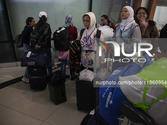 Indonesian citizens (WNI) walk out of the arrivals terminal shortly after arriving from Syria at Soekarno-Hatta Airport in Tangerang, Banten...