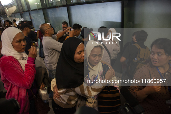 Indonesian citizens (WNI) walk out of the arrivals terminal shortly after arriving from Syria at Soekarno-Hatta Airport in Tangerang, Banten...