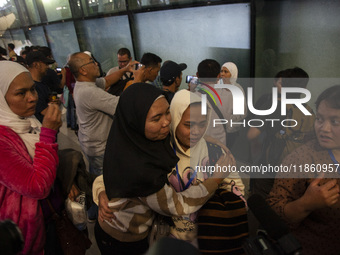 Indonesian citizens (WNI) walk out of the arrivals terminal shortly after arriving from Syria at Soekarno-Hatta Airport in Tangerang, Banten...