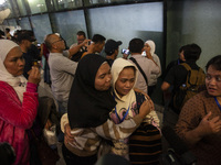 Indonesian citizens (WNI) walk out of the arrivals terminal shortly after arriving from Syria at Soekarno-Hatta Airport in Tangerang, Banten...