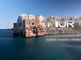 This image captures Lama Monachile, a famous cove in Polignano a Mare, Italy, on October 5, 2020. (