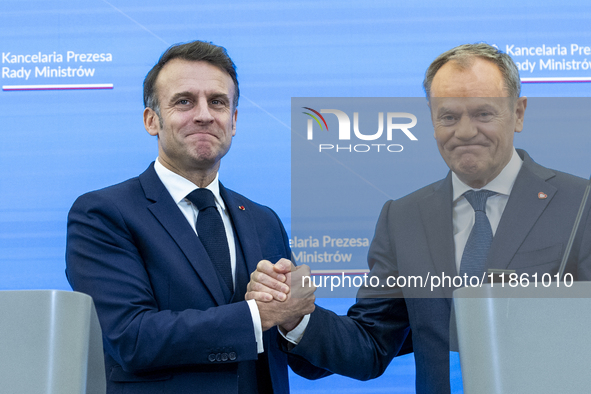 French President Emmanuel Macron (L) and Prime Minister Donald Tusk after a  press meeting at the Prime Minister's Office in Warsaw. The lea...