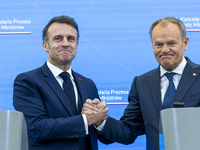 French President Emmanuel Macron (L) and Prime Minister Donald Tusk after a  press meeting at the Prime Minister's Office in Warsaw. The lea...