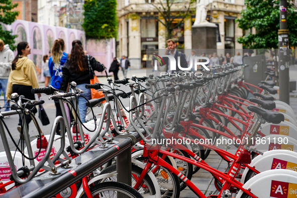 A line of Velo Antwerp rental bicycles stands ready for use at a busy city center location in Antwerp, Belgium, on July 31, 2023. As pedestr...