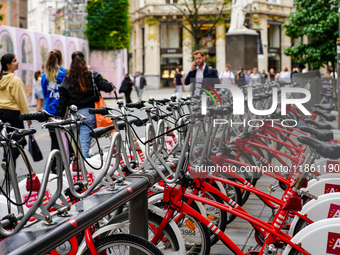 A line of Velo Antwerp rental bicycles stands ready for use at a busy city center location in Antwerp, Belgium, on July 31, 2023. As pedestr...