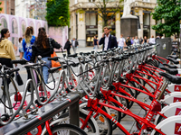 A line of Velo Antwerp rental bicycles stands ready for use at a busy city center location in Antwerp, Belgium, on July 31, 2023. As pedestr...