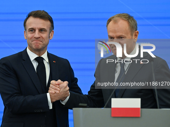 WARSAW, POLAND - DECEMBER 12:
French President Emmanuel Macron (L) and Polish Prime Minister Donald Tusk (R) at the end a joint press confer...