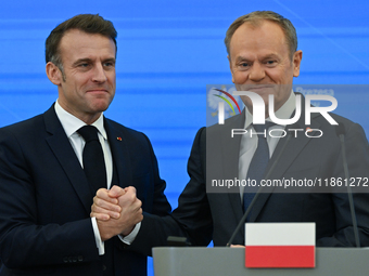 WARSAW, POLAND - DECEMBER 12:
French President Emmanuel Macron (L) and Polish Prime Minister Donald Tusk (R) at the end a joint press confer...