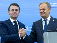 French President Emmanuel Macron, left and Prime Minister Donald Tusk after a  press meeting at the Prime Minister's Office in Warsaw. The l...