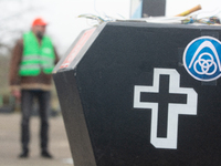 A coffin with the IGM logo is seen as a hundred Thyssenkrupp Europe Steel workers march against planned job cuts before heading to the Works...