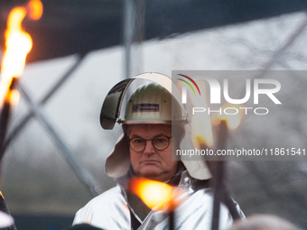 One hundred Thyssenkrupp Europe Steel workers march against planned job cuts before heading to the Works Council meeting in Duisburg, German...