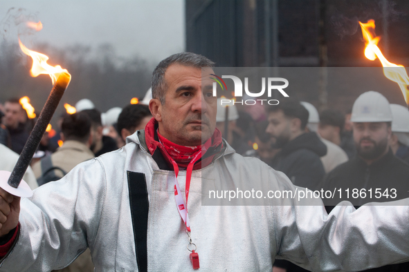 One hundred Thyssenkrupp Europe Steel workers march against planned job cuts before heading to the Works Council meeting in Duisburg, German...