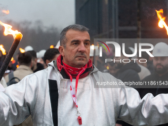 One hundred Thyssenkrupp Europe Steel workers march against planned job cuts before heading to the Works Council meeting in Duisburg, German...