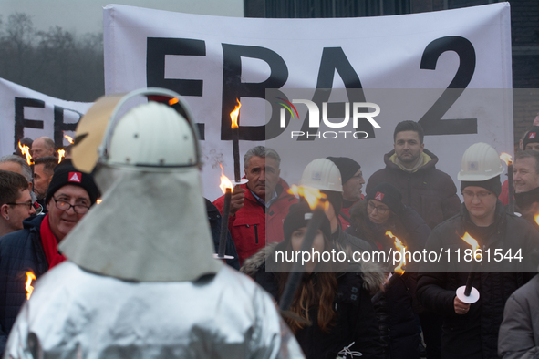 One hundred Thyssenkrupp Europe Steel workers march against planned job cuts before heading to the Works Council meeting in Duisburg, German...