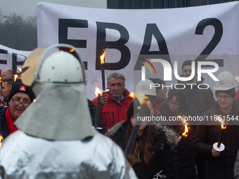 One hundred Thyssenkrupp Europe Steel workers march against planned job cuts before heading to the Works Council meeting in Duisburg, German...