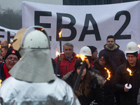 One hundred Thyssenkrupp Europe Steel workers march against planned job cuts before heading to the Works Council meeting in Duisburg, German...