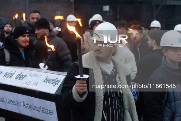 One hundred Thyssenkrupp Europe Steel workers march against planned job cuts before heading to the Works Council meeting in Duisburg, German...