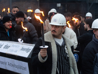 One hundred Thyssenkrupp Europe Steel workers march against planned job cuts before heading to the Works Council meeting in Duisburg, German...