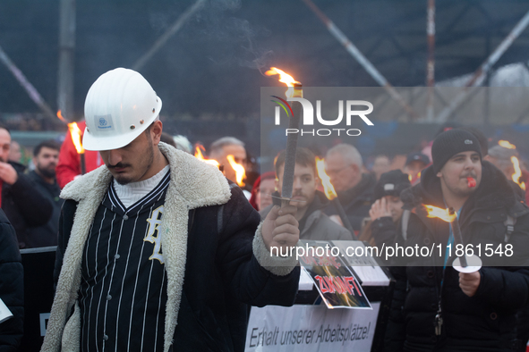 A hundred Thyssenkrupp Europe Steel workers march with a coffin against planned job cuts before heading to the Works Council meeting in Duis...