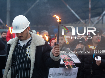 A hundred Thyssenkrupp Europe Steel workers march with a coffin against planned job cuts before heading to the Works Council meeting in Duis...