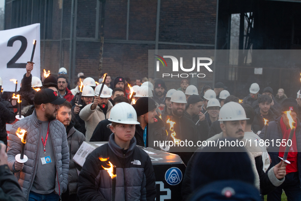 A hundred Thyssenkrupp Europe Steel workers march with a coffin against planned job cuts before heading to the Works Council meeting in Duis...