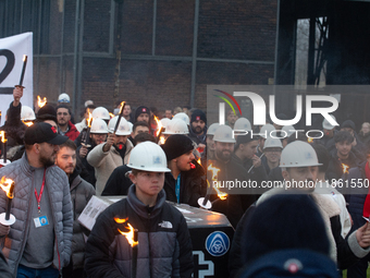 A hundred Thyssenkrupp Europe Steel workers march with a coffin against planned job cuts before heading to the Works Council meeting in Duis...