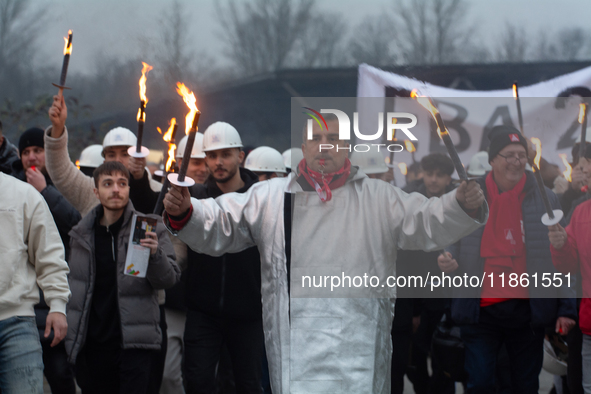 A hundred Thyssenkrupp Europe Steel workers march with a coffin against planned job cuts before heading to the Works Council meeting in Duis...