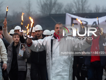 A hundred Thyssenkrupp Europe Steel workers march with a coffin against planned job cuts before heading to the Works Council meeting in Duis...