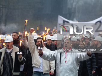 A hundred Thyssenkrupp Europe Steel workers march with a coffin against planned job cuts before heading to the Works Council meeting in Duis...