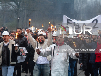 A hundred Thyssenkrupp Europe Steel workers march with a coffin against planned job cuts before heading to the Works Council meeting in Duis...