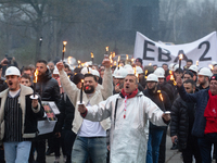 A hundred Thyssenkrupp Europe Steel workers march with a coffin against planned job cuts before heading to the Works Council meeting in Duis...