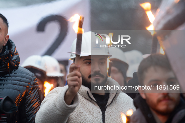 A hundred Thyssenkrupp Europe Steel workers march with a coffin against planned job cuts before heading to the Works Council meeting in Duis...