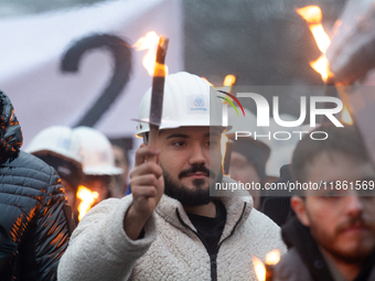 A hundred Thyssenkrupp Europe Steel workers march with a coffin against planned job cuts before heading to the Works Council meeting in Duis...