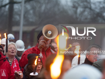 A hundred Thyssenkrupp Europe Steel workers march with a coffin against planned job cuts before heading to the Works Council meeting in Duis...