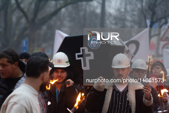 A hundred Thyssenkrupp Europe Steel workers march with a coffin against planned job cuts before heading to the Works Council meeting in Duis...