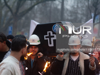 A hundred Thyssenkrupp Europe Steel workers march with a coffin against planned job cuts before heading to the Works Council meeting in Duis...