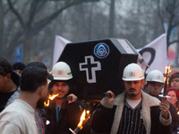 A hundred Thyssenkrupp Europe Steel workers march with a coffin against planned job cuts before heading to the Works Council meeting in Duis...