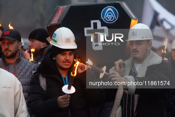 A hundred Thyssenkrupp Europe Steel workers march with a coffin against planned job cuts before heading to the Works Council meeting in Duis...